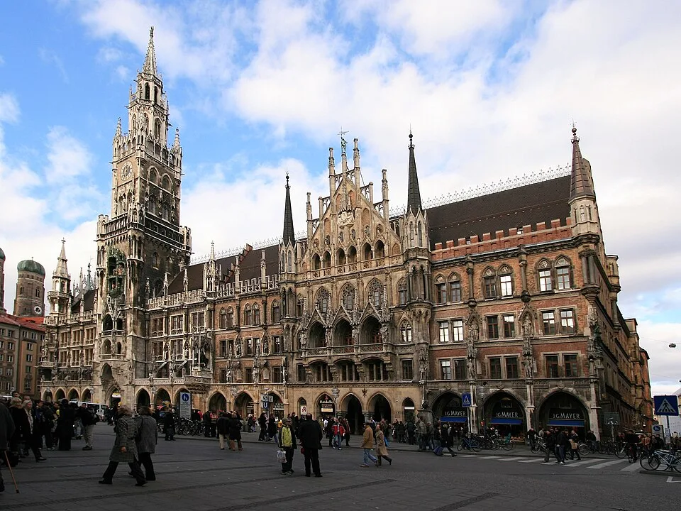 New Town Hall at Marienplatz in Munich with neo-Gothic architecture and tourists exploring the historic square