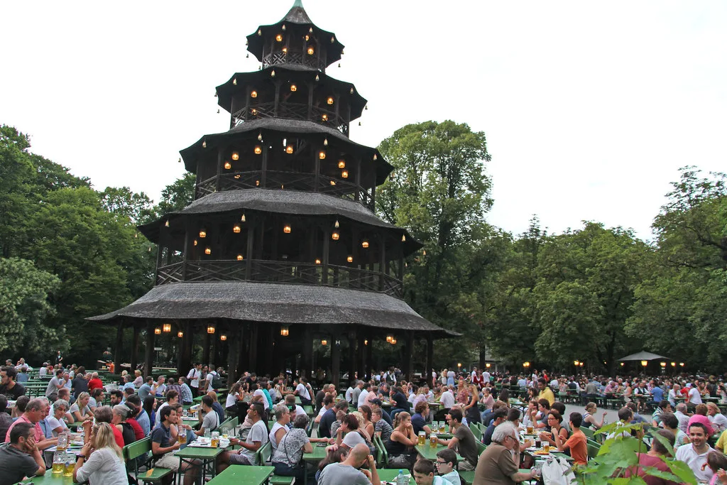 Crowds enjoying Bavarian food and beer at the Chinese Tower in the English Garden Munich, a popular landmark in the English Garden