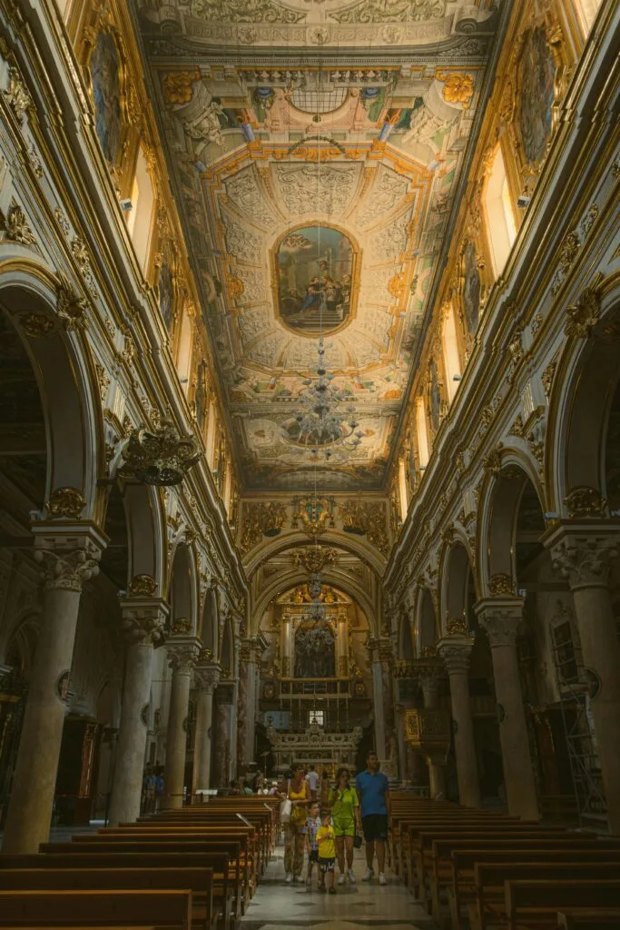 Interior of Matera Cathedral, Italy, with stunning frescoed ceiling and ornate arches