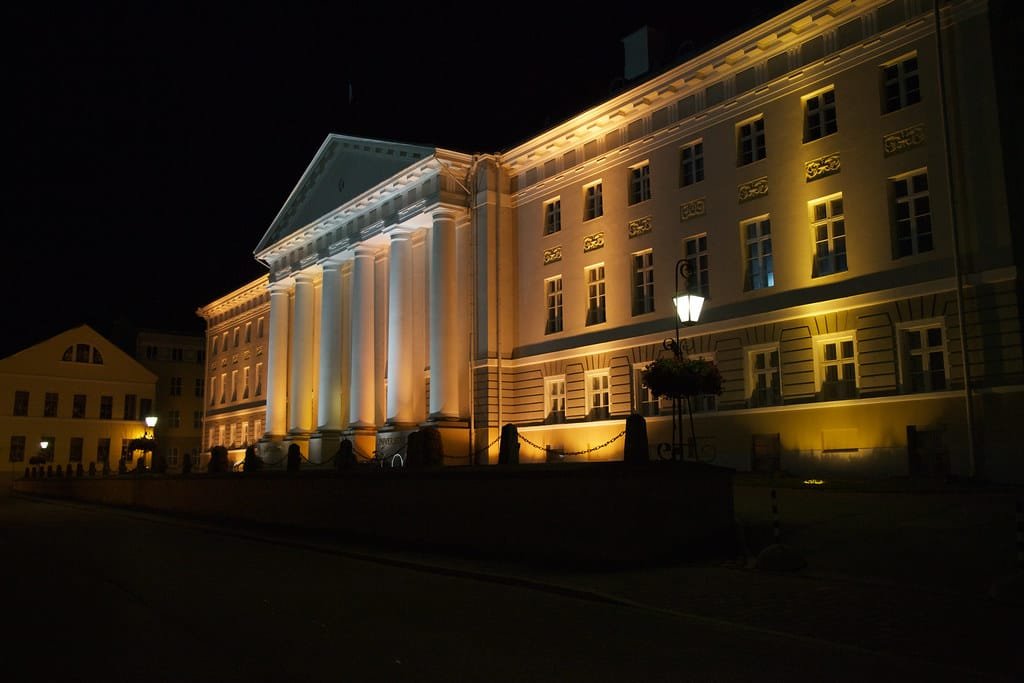 Tartu University main building glowing at night with elegant architecture