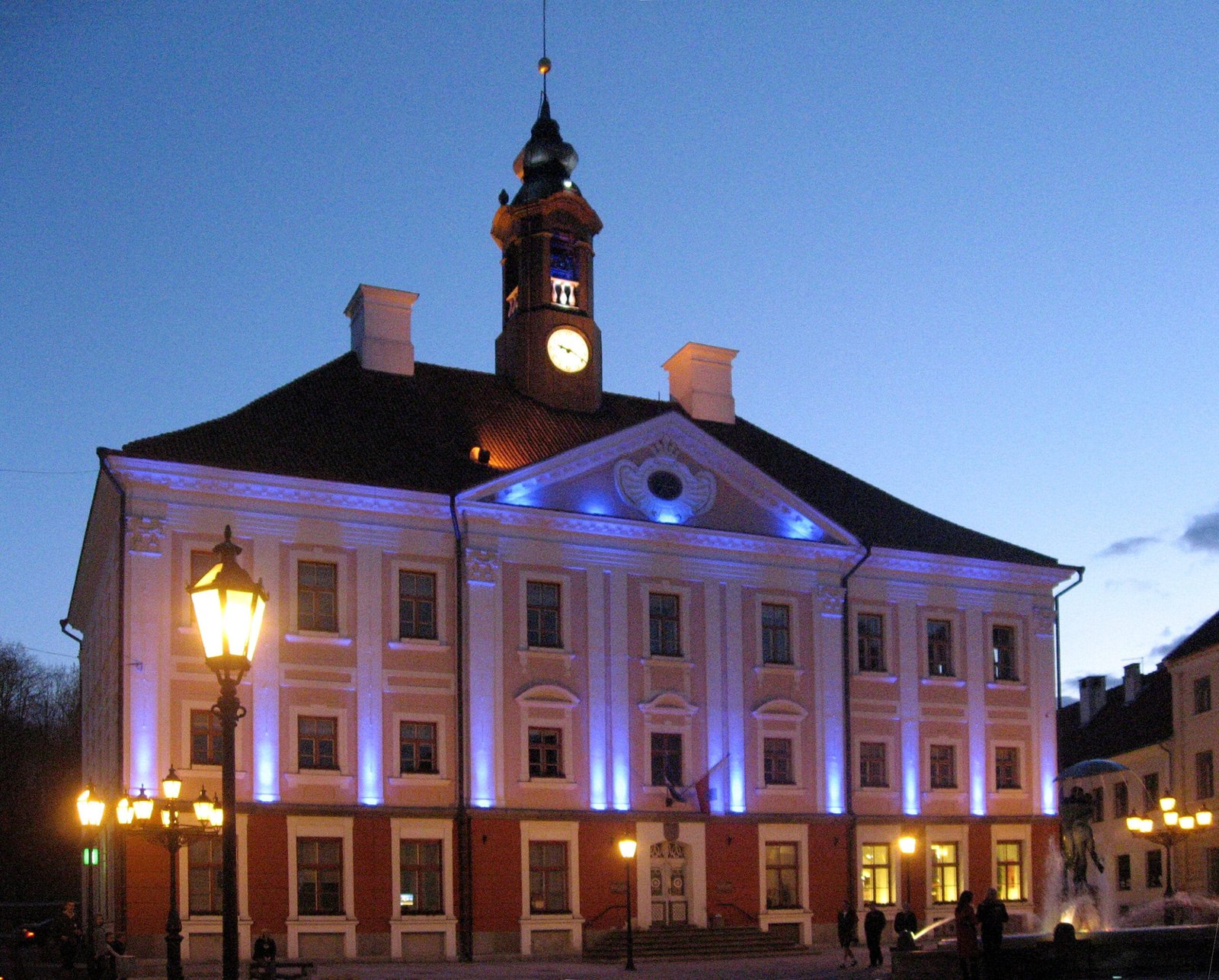 Tartu Town Hall illuminated with blue lights during twilight