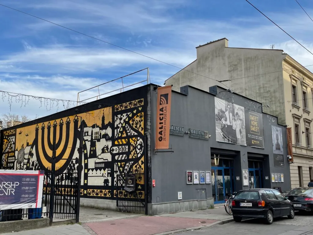 Galicia Jewish Museum in Kazimierz, Kraków – vibrant mural featuring a menorah and scenes of Jewish heritage, reflecting the area's rich cultural history and efforts in Holocaust remembrance