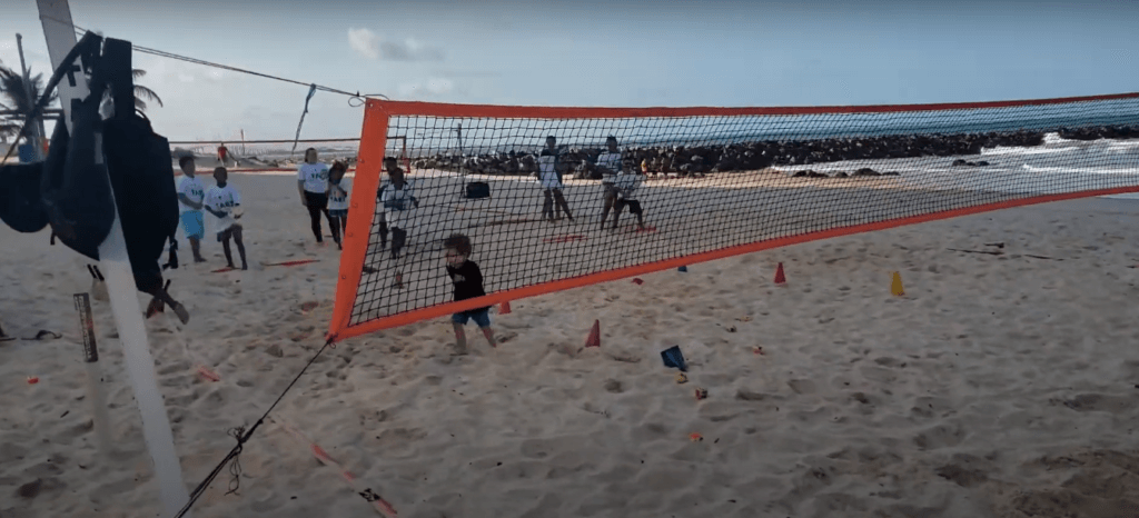A volleyball net is positioned on the sandy shore, inviting visitors to enjoy a fun beach game — one of the active things to do in South Beach Miami