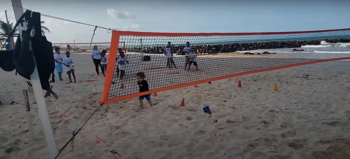 A volleyball net is positioned on the beach, inviting players to enjoy a game in Miami