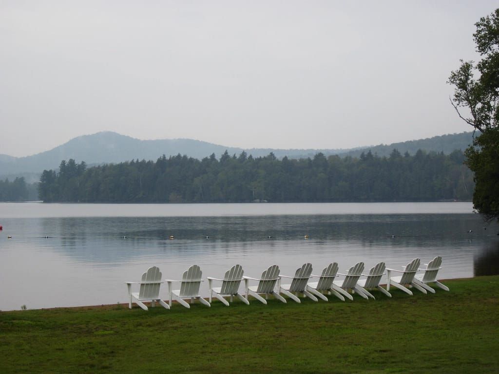 Paddling a canoe on Blue Mountain Lake with surrounding Adirondack Mountains