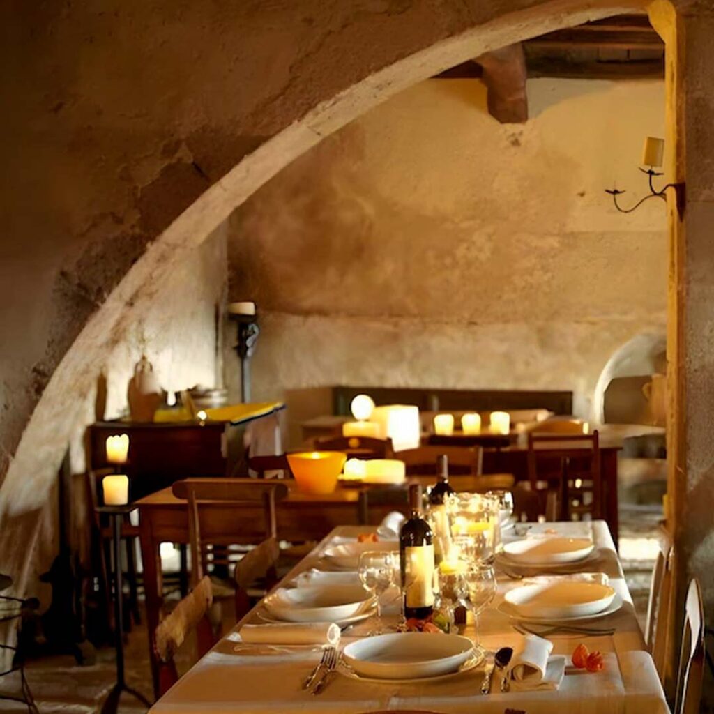 candle-lit 13th-century church with breakfast tables inside Sextantio Matera Italy
