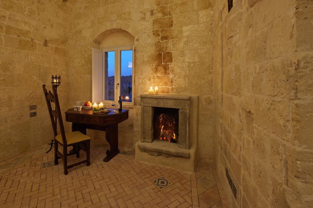 local craftsmen restoring ancient stone walls inside Sextantio Matera