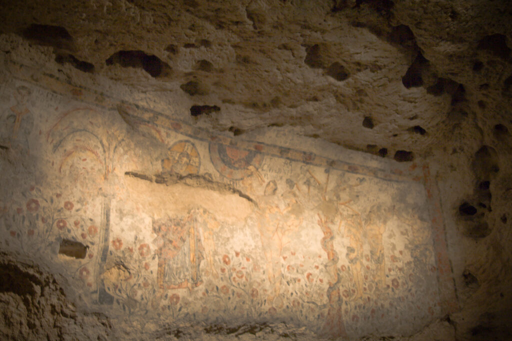  vivid fresco of Adam and Eve on limestone wall inside the Crypt of the Original Sin near Matera Italy