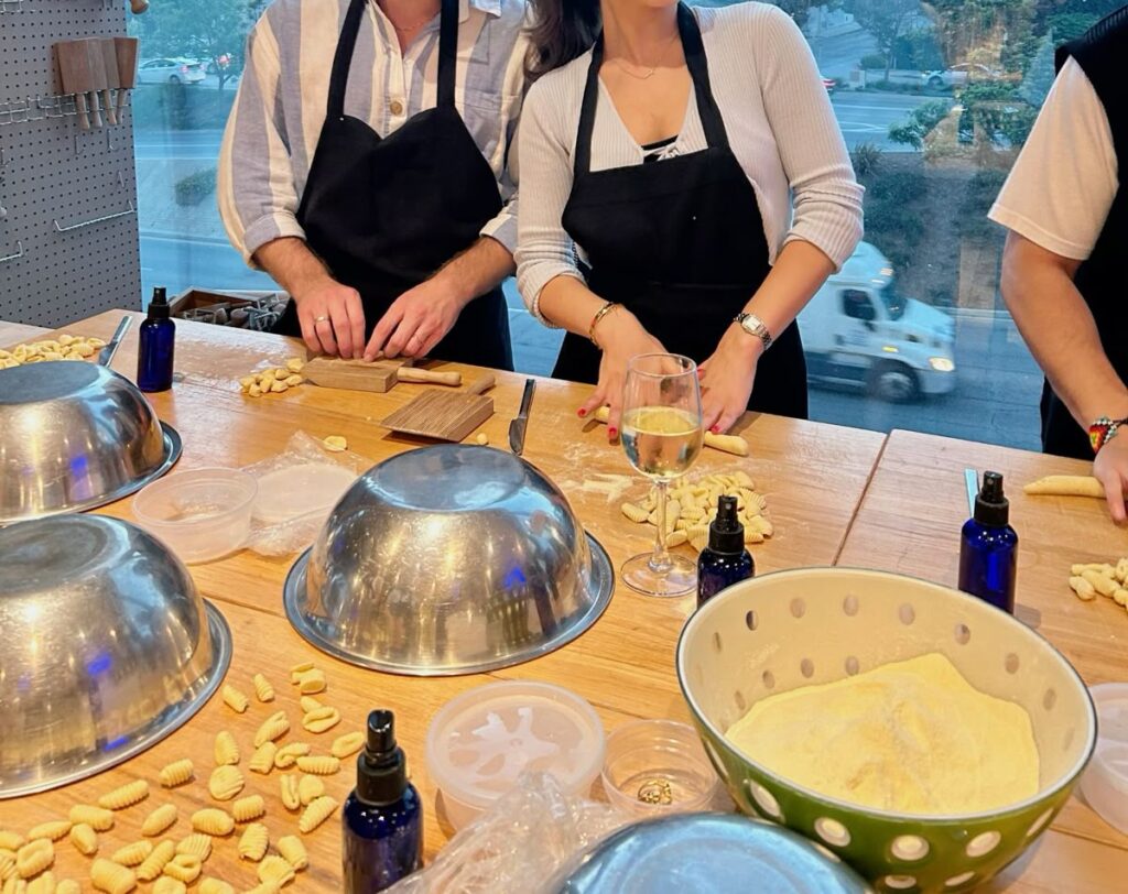 travellers making orecchiette pasta in traditional Matera kitchen Italy