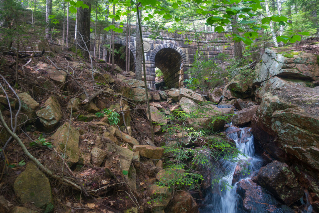 Deer Brook cascades - seasonal waterfalls flowing between mountains in Acadia National Park Maine