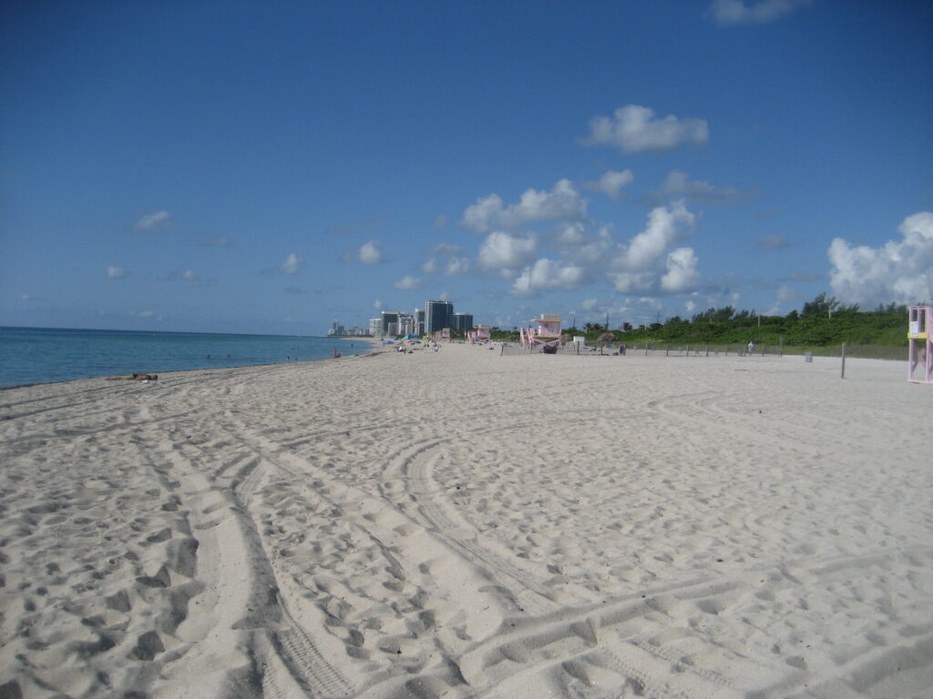 Haulover Beach Miami – wide sandy shores, clear turquoise water, and vibrant beachgoers, known as a famous clothing-optional beach, one of the best beaches in Miami Florida for adventurous and unique beach experiences