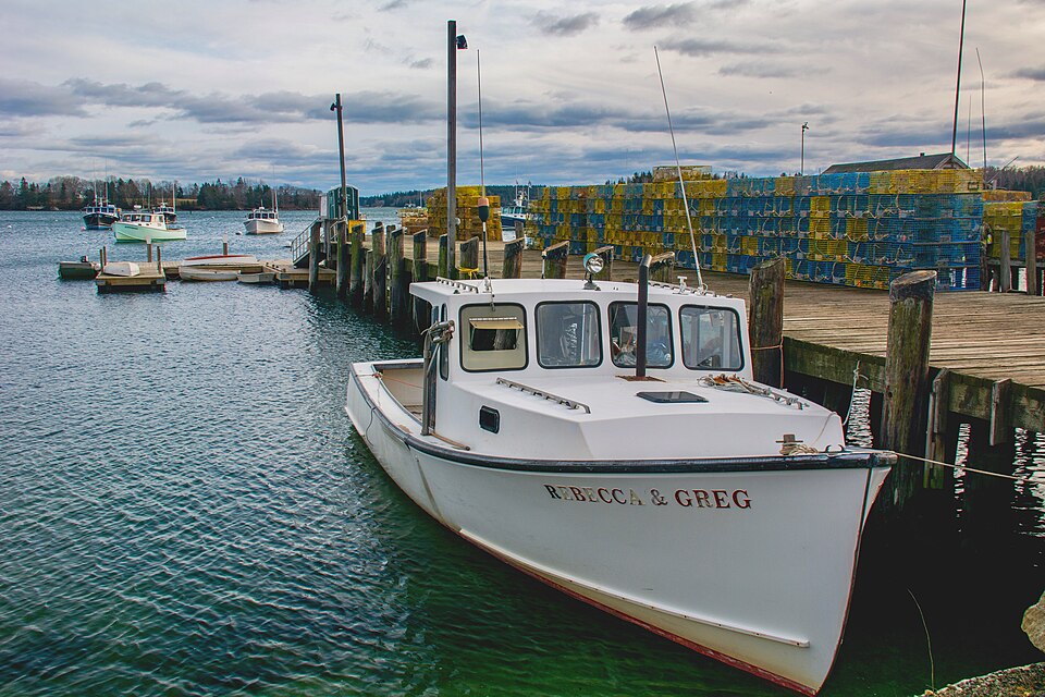 Travelers on a Lobster Boat Tour learning how traps are pulled, one of the most authentic things to do in Portland Maine