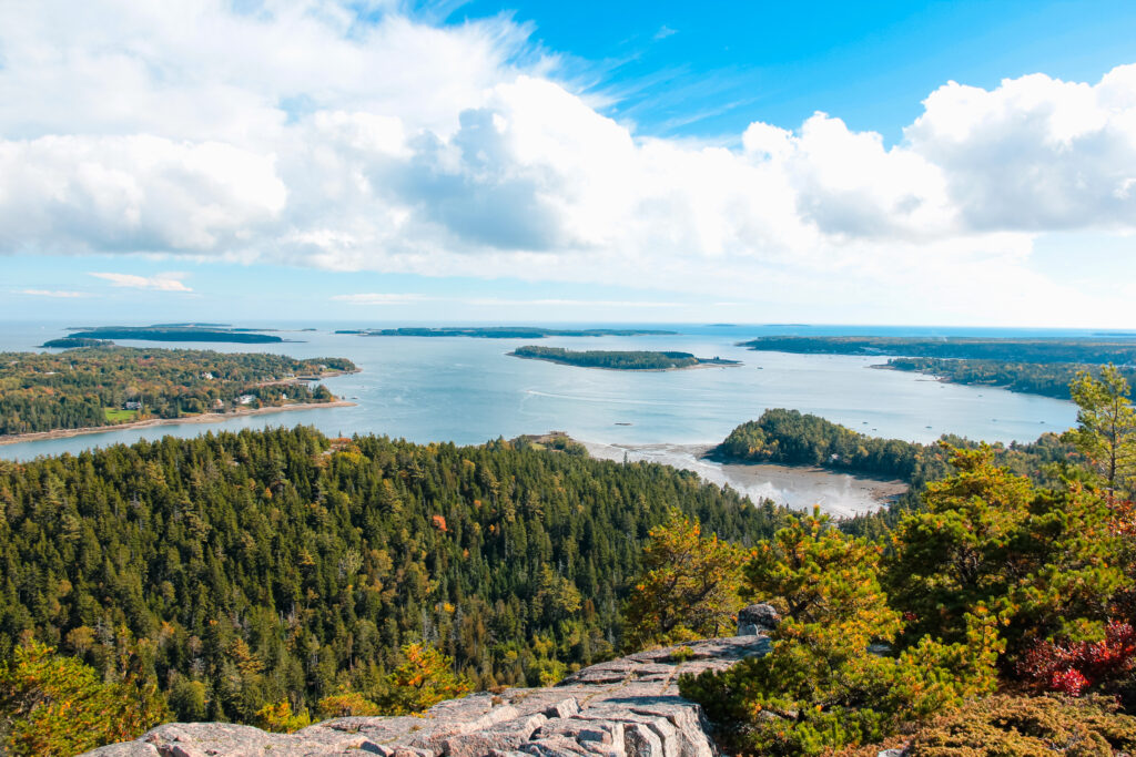 Scenic summer view of Acadia National Park’s coastline and forest trails, highlighting the best time to go to Acadia National Park and more things to do in Acadia National Park.