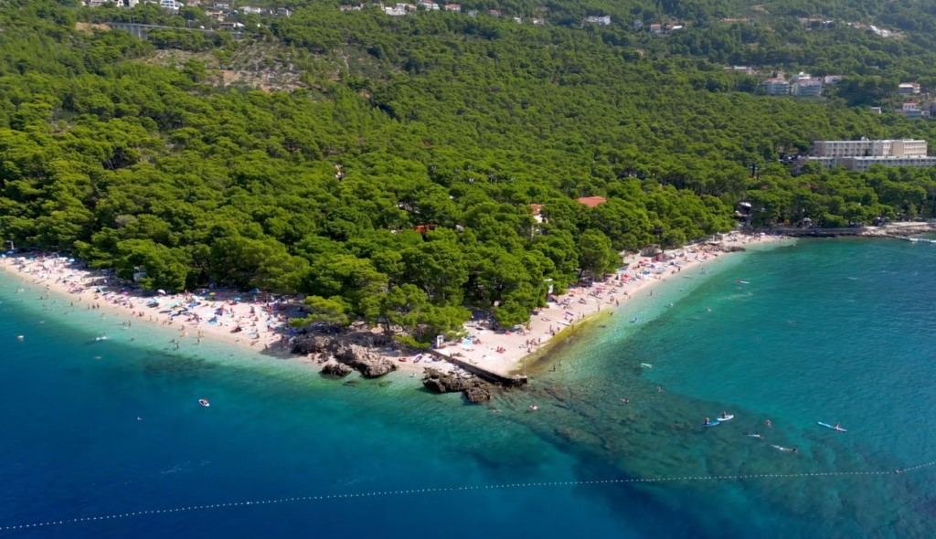 Aerial view of Punta Rata Beach, a 400-meter stretch, bordered by lush forested areas.