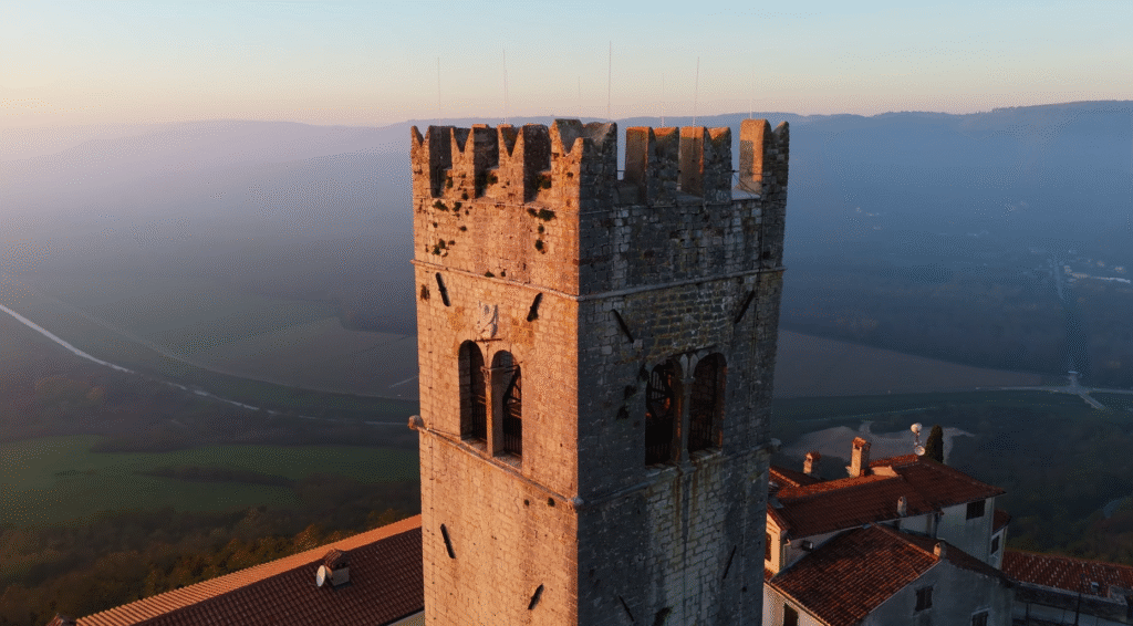Bell Tower of St. Stephen’s Church Motovun rising above the hilltop town, showcasing its historic stone architecture against a clear blue sky