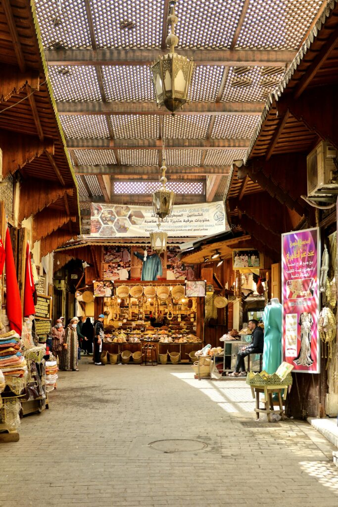 Bustling covered souk in a Moroccan medina with vendors selling crafts, ideal for a Morocco travel itinerary