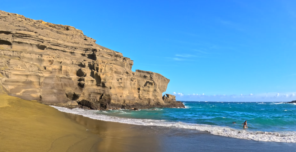 Green sand beach ocean waves turquoise water olivine sand wet Papakōlea Big Island Hawaii swimming conditions