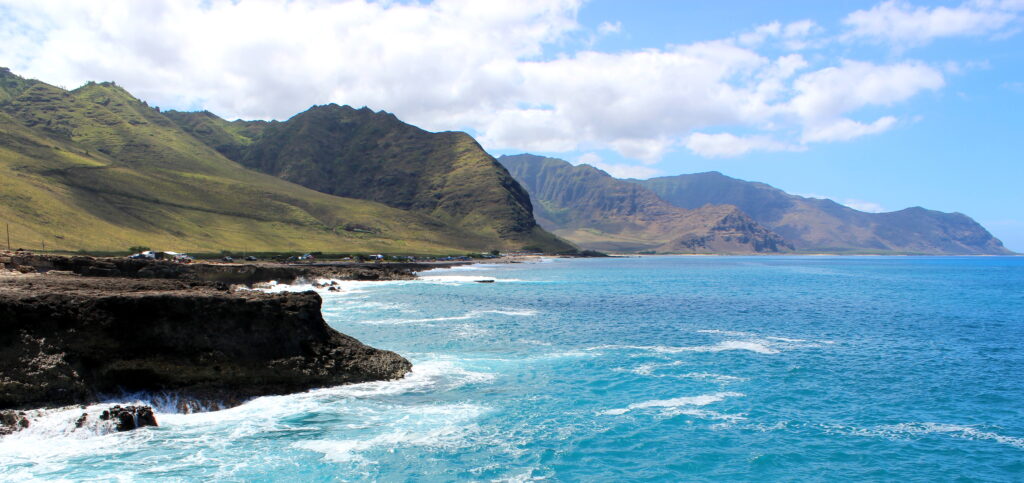 Best hikes on Oahu North Shore showcasing the rugged coastal scenery along the Kaʻena Point Trail with mountains and ocean views