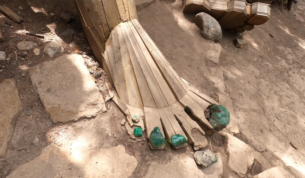 Close-up of the Breckenridge troll’s wooden foot with green stones, part of the famous troll sculpture in Breckenridge, Colorado