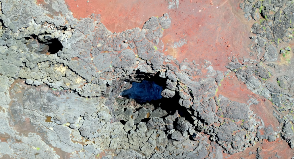 Ancient Hawaiian canoe mooring holes hand-carved into volcanic rock at Ka Lae South Point Big Island