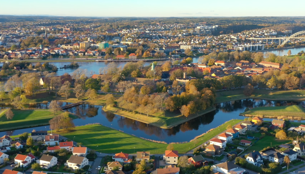Drone view of Fredrikstad, Norway, showing riverside parks, historic buildings, and colorful residential areas at sunset, capturing the charm of a city connected to the largest cities in Norway such as Oslo, Bergen, Trondheim, and Stavange