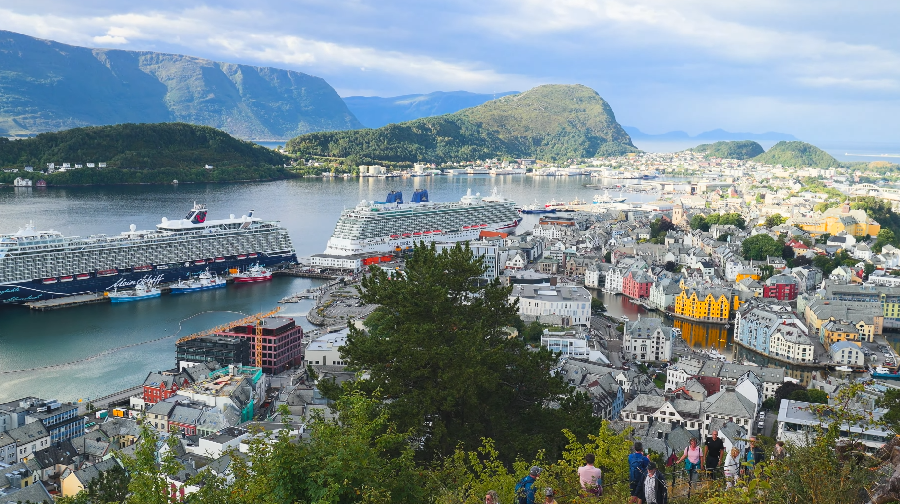 Panoramic view from Aksla viewpoint Ålesund showing colorful Art Nouveau buildings, cruise ships, and fjord landscape in Norway